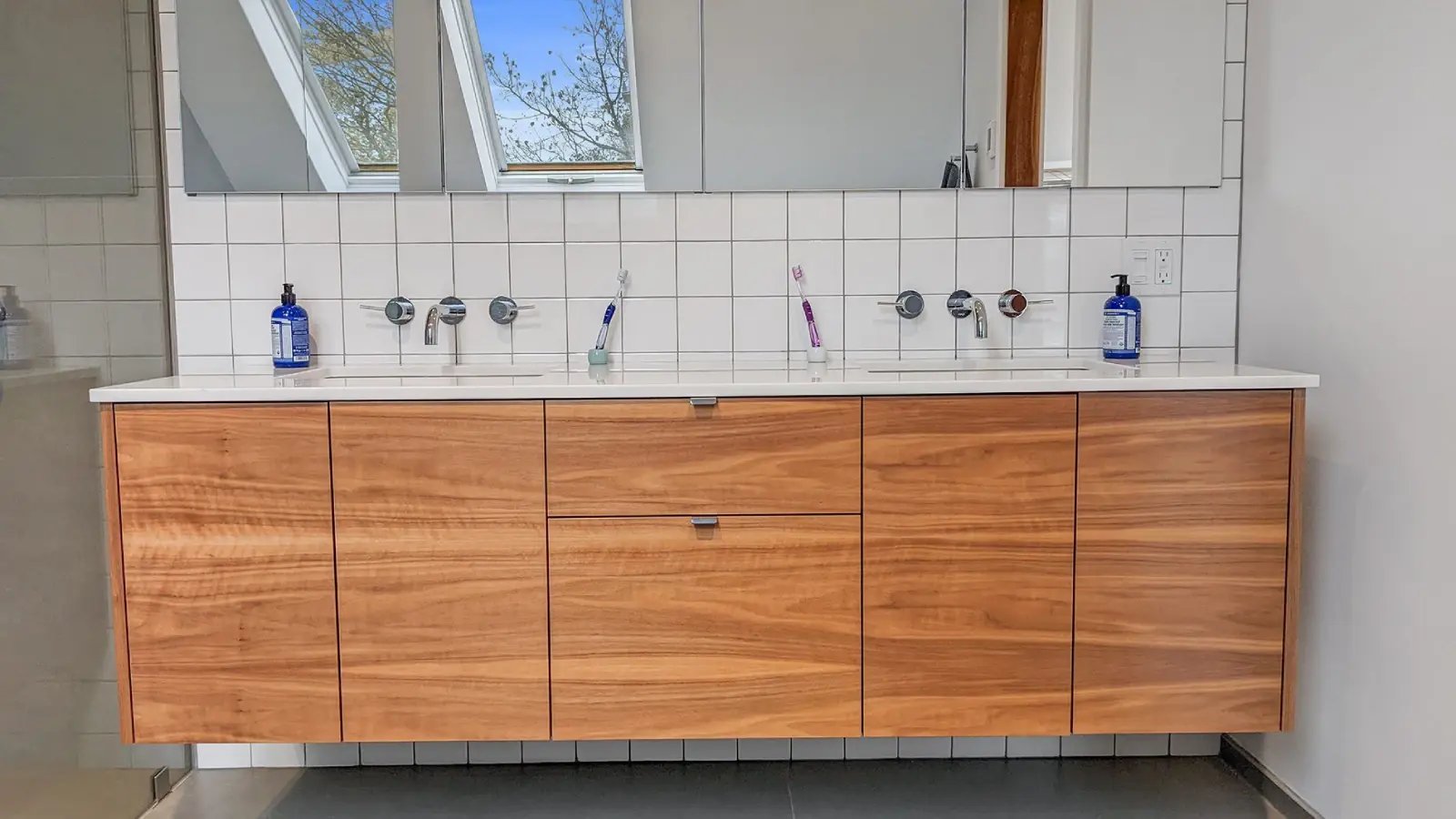 bathroom vanity with square tile backsplash