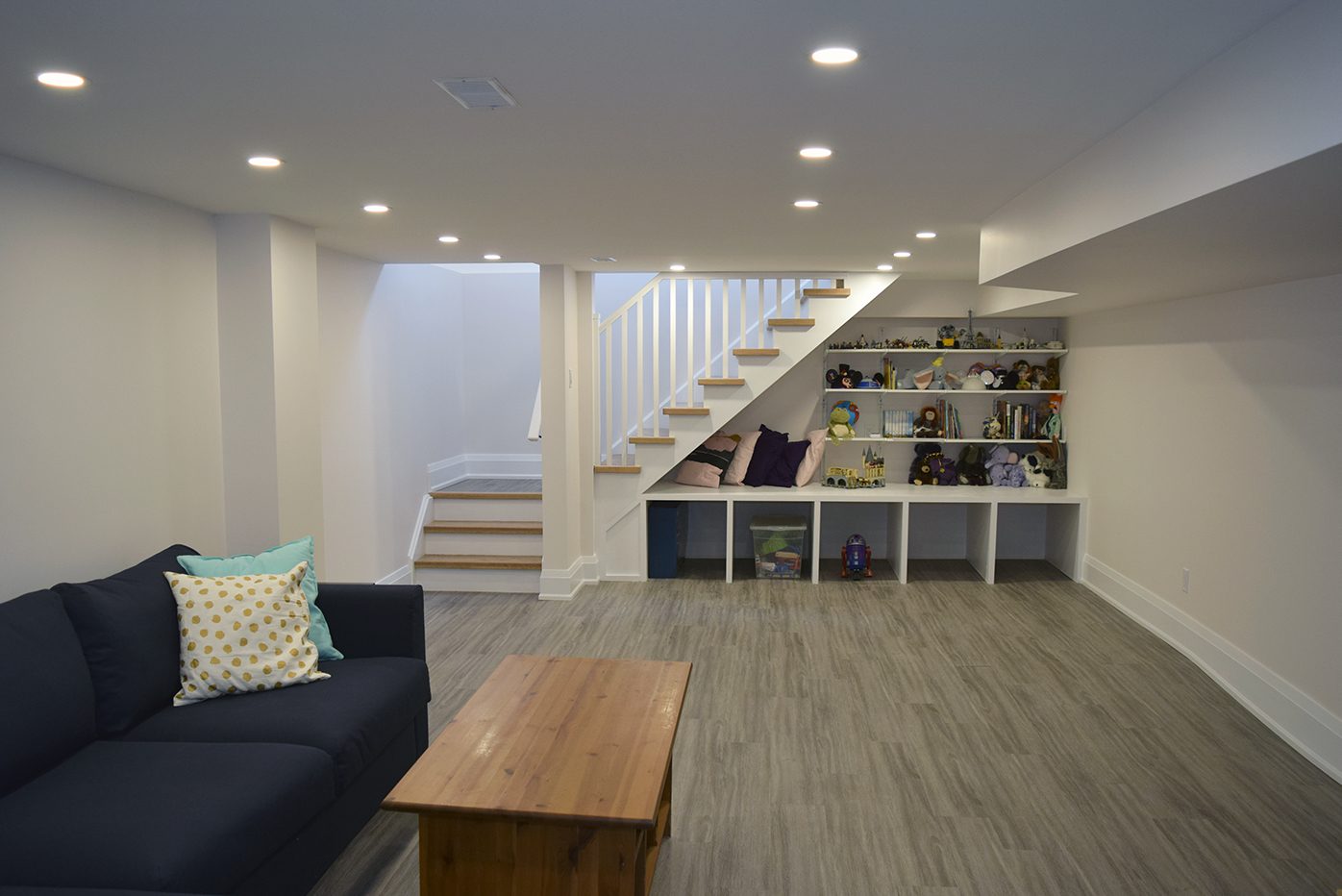 Toronto basement renovation, refreshed layout, stairs and built in shelves